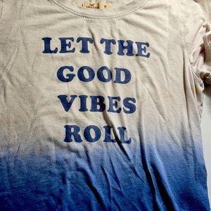 Blue and white shirt that says let the good vibes roll